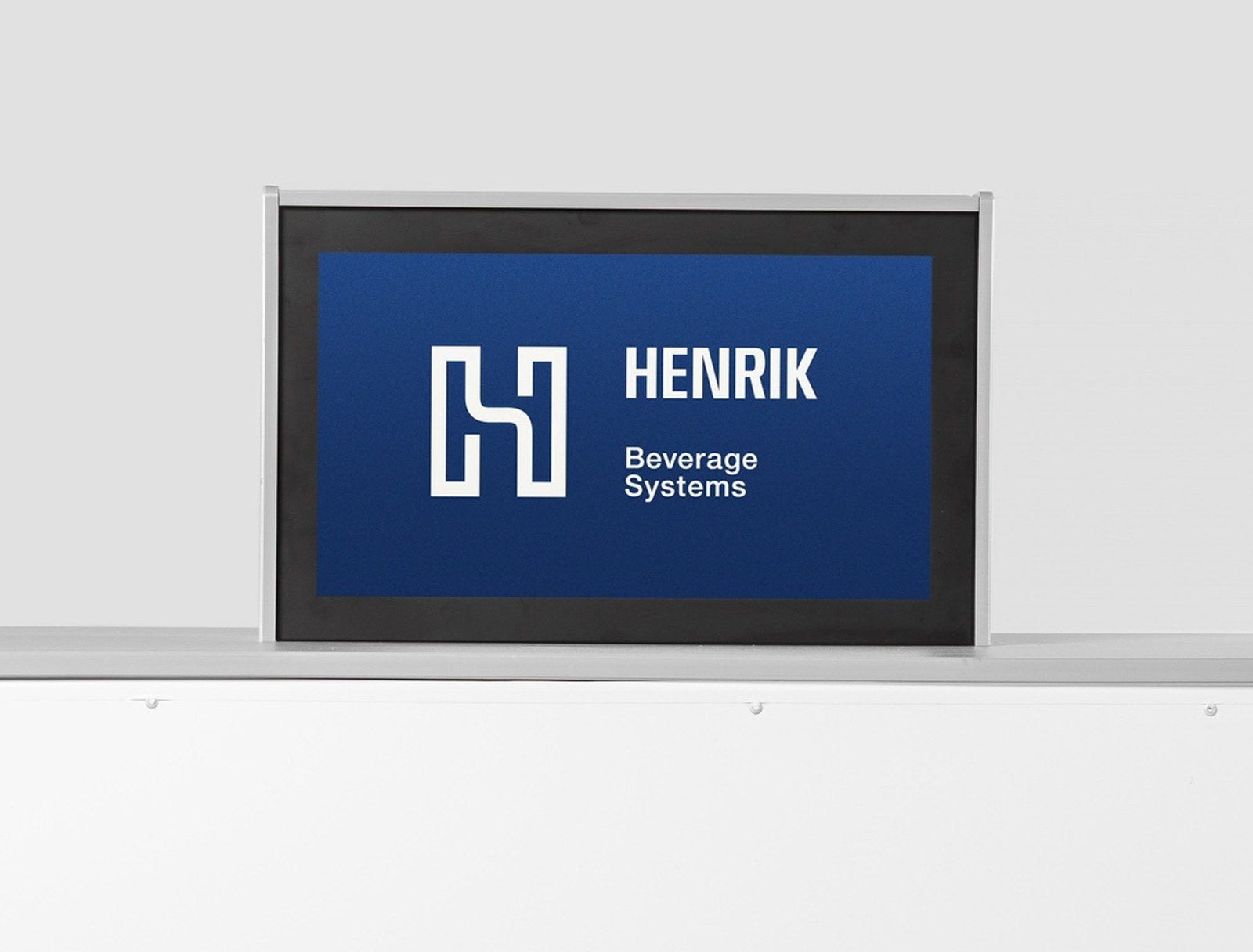 The H1 Pro 21.5-inch customer-facing display mounted on the cabinet top, showing the Henrik Beverage Systems lockup